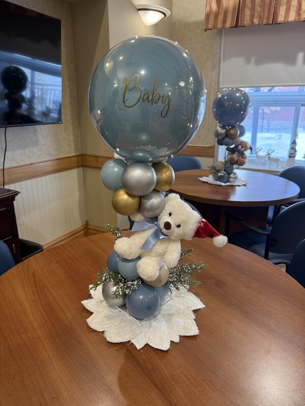 Elegant baby shower balloon décor with gold accents