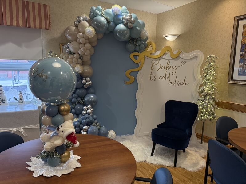 Pink and white baby shower balloon setup