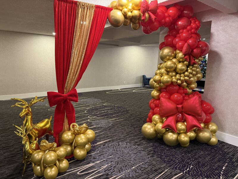 Red and gold holiday balloon arch for Christmas celebration