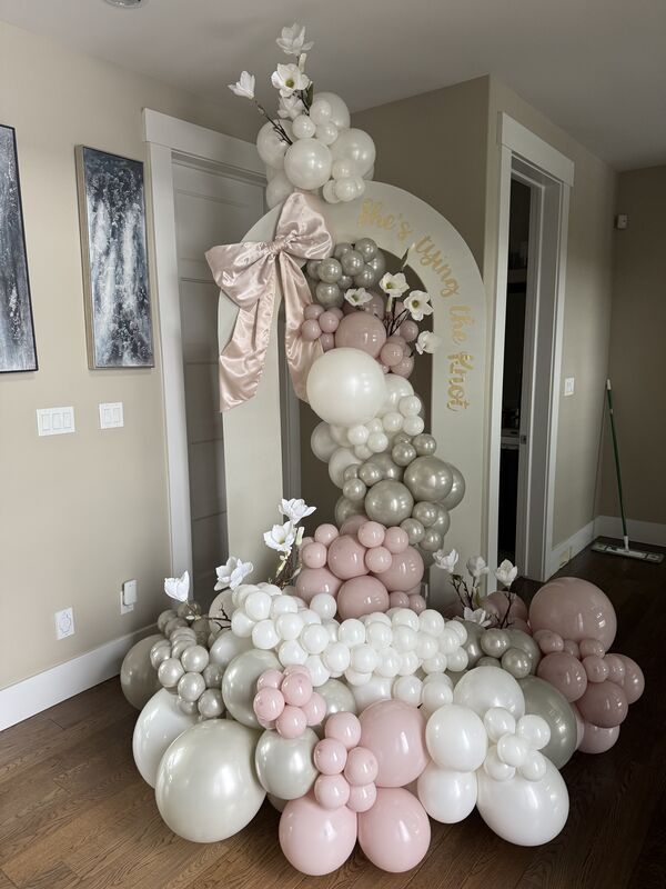 Romantic wedding setup with blush and rose balloon styling